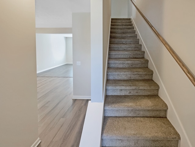 staircase with light hardwood / wood-style floors