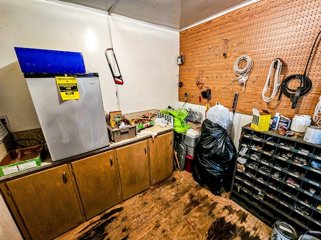 miscellaneous room with wood-type flooring and a workshop area