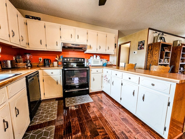 kitchen featuring a textured ceiling, dark hardwood / wood-style flooring, black appliances, extractor fan, and kitchen peninsula