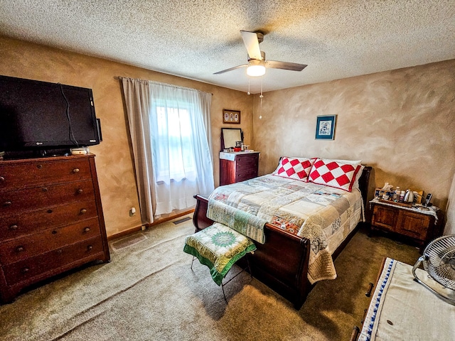 carpeted bedroom with a textured ceiling and ceiling fan