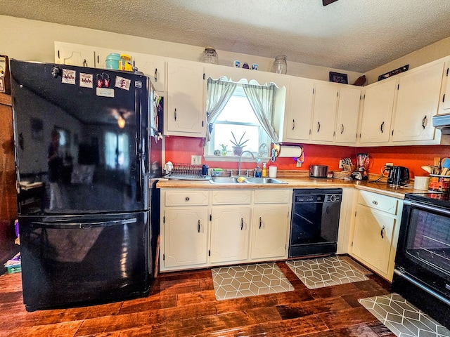 kitchen with a textured ceiling, black appliances, dark hardwood / wood-style flooring, sink, and white cabinets