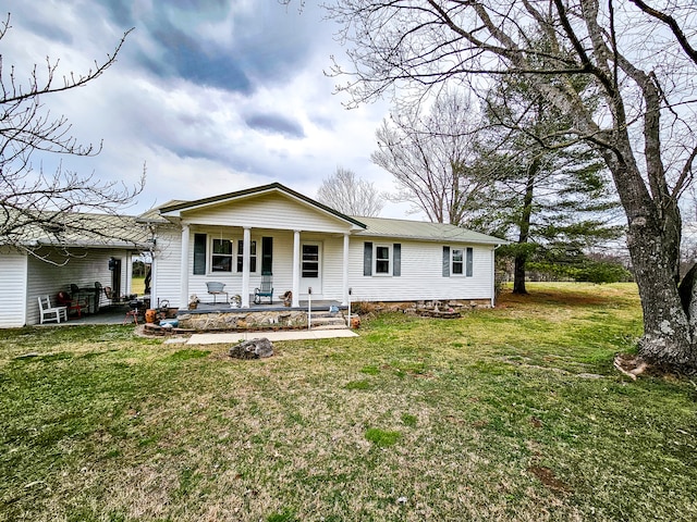 view of front of house with a patio area and a front yard