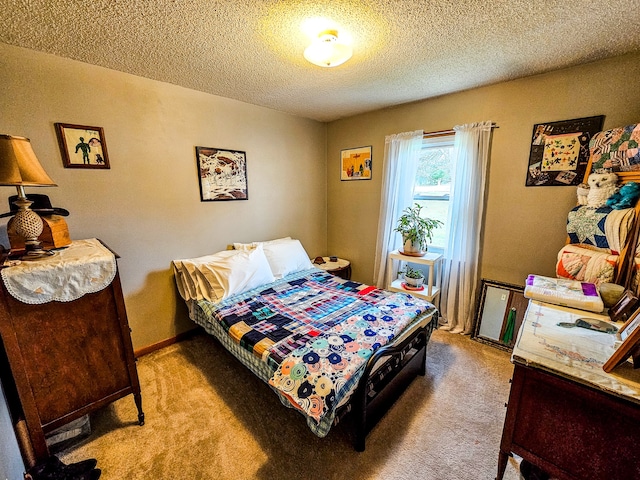 bedroom with light colored carpet and a textured ceiling