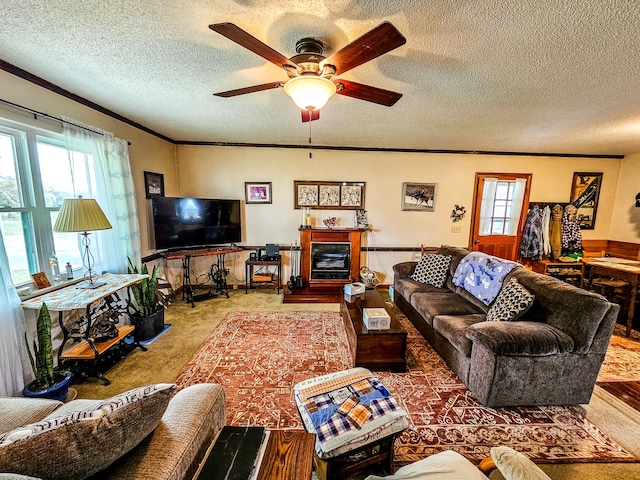 living room with a textured ceiling, a wealth of natural light, and ceiling fan