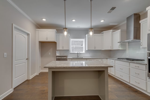 7112 Maddenwood Ln, Hermitage, TN 37076 - kitchen featuring appliances with stainless steel finishes, wall chimney exhaust hood, tasteful backsplash, ornamental molding, and a kitchen island
