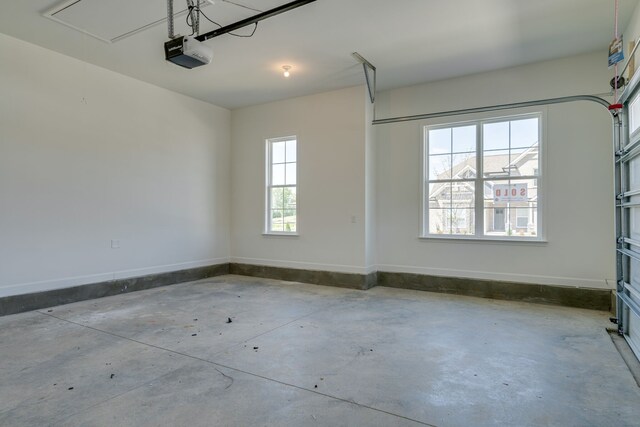 7112 Maddenwood Ln, Hermitage, TN 37076 - garage featuring a garage door opener and baseboards