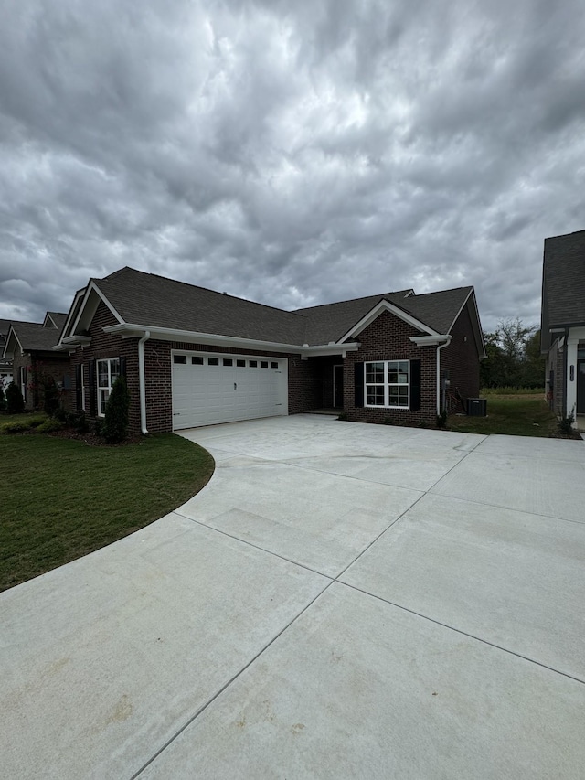 7112 Maddenwood Ln, Hermitage, TN 37076 - ranch-style house with concrete driveway, an attached garage, brick siding, a front lawn, and central air condition unit
