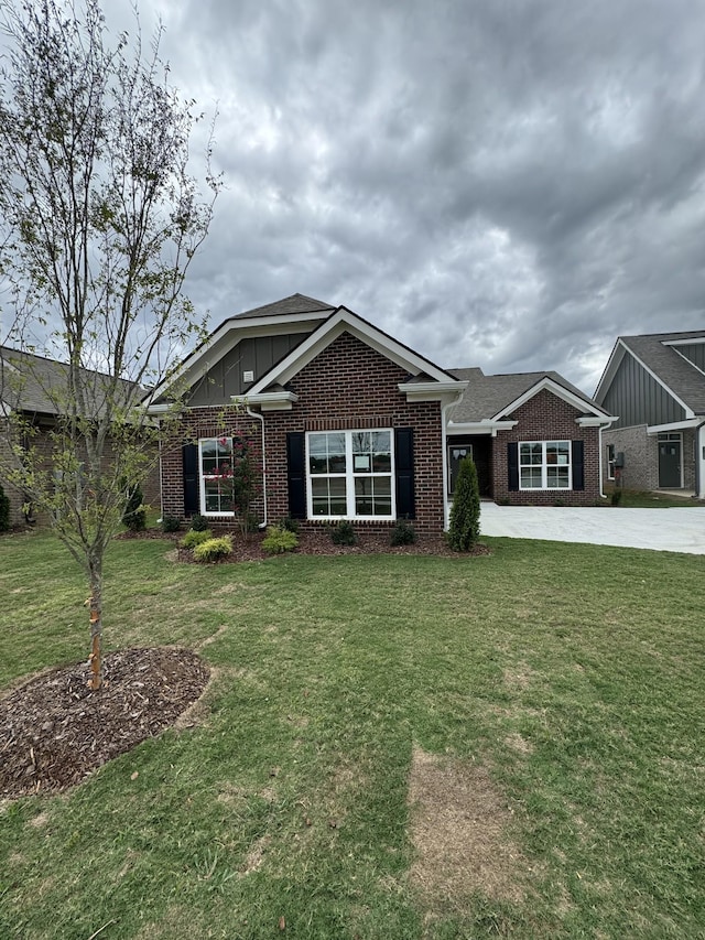 7112 Maddenwood Ln, Hermitage, TN 37076 - view of front of house with brick siding, a front lawn, and concrete driveway
