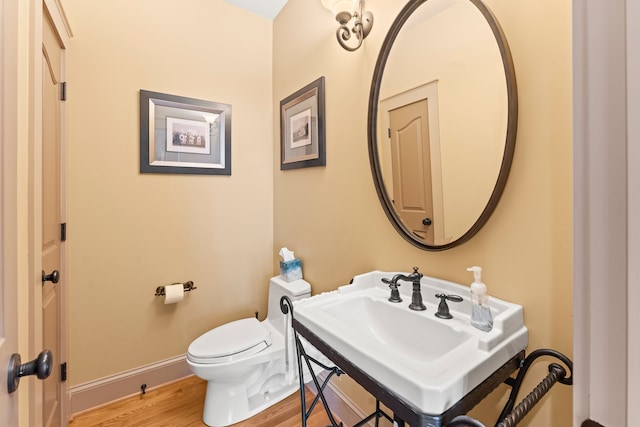 bathroom featuring hardwood / wood-style floors, toilet, and sink