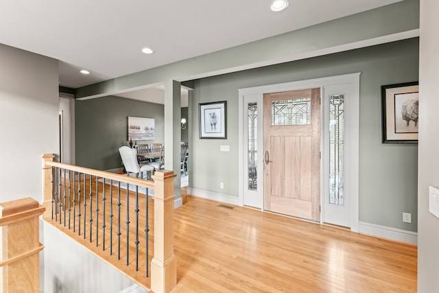 foyer entrance with light hardwood / wood-style floors