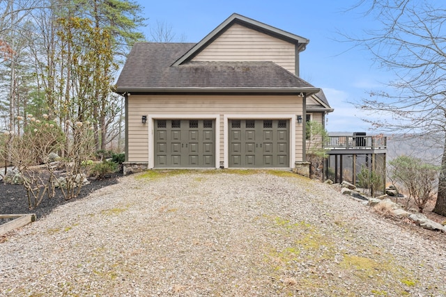 exterior space featuring a wooden deck and a garage