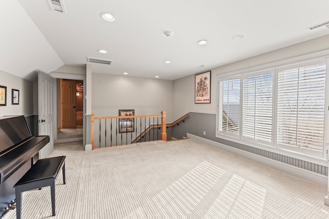 miscellaneous room with light colored carpet and vaulted ceiling