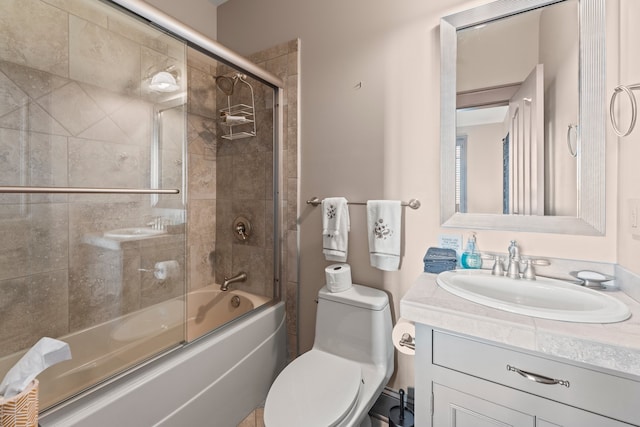 full bathroom with shower / bath combination with glass door, vanity, and toilet