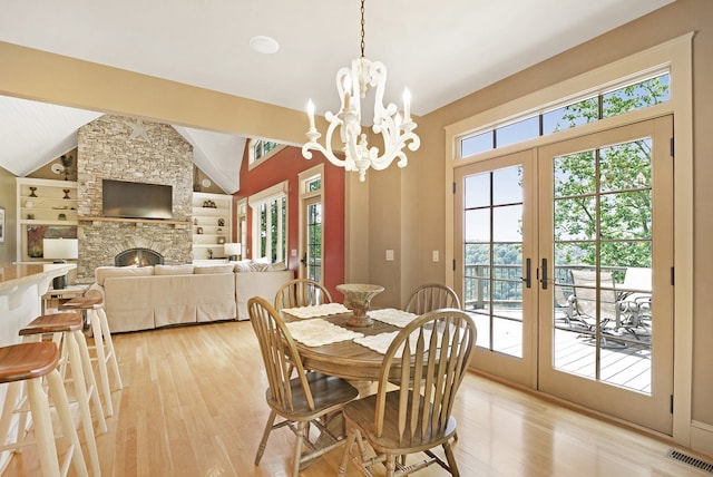 dining space with built in shelves, plenty of natural light, and light hardwood / wood-style floors