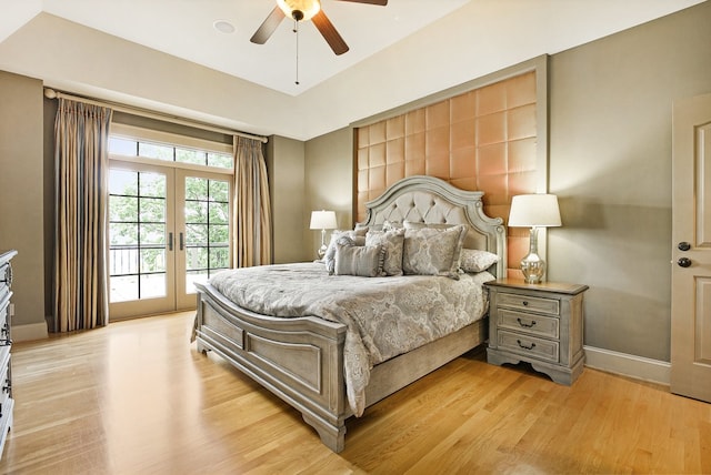 bedroom featuring french doors, light hardwood / wood-style flooring, ceiling fan, and access to outside