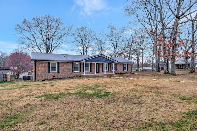 rear view of property with a lawn