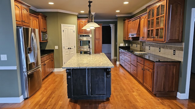 kitchen with decorative backsplash, light hardwood / wood-style floors, pendant lighting, and stainless steel appliances