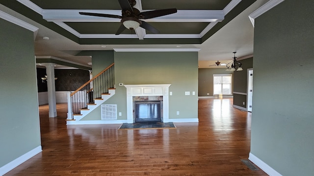 unfurnished living room featuring a fireplace, wood-type flooring, coffered ceiling, ceiling fan, and crown molding