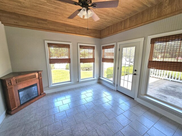 interior space with a wealth of natural light, ceiling fan, and wooden ceiling