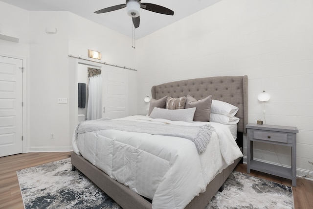 bedroom with ceiling fan and hardwood / wood-style floors