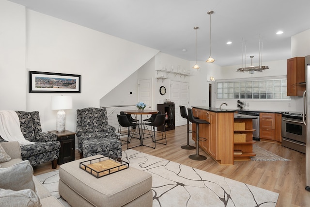 living room with light hardwood / wood-style floors and sink