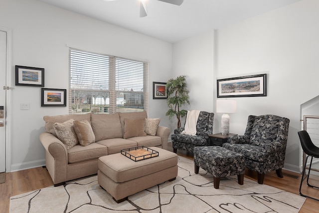 living room with ceiling fan and light wood-type flooring