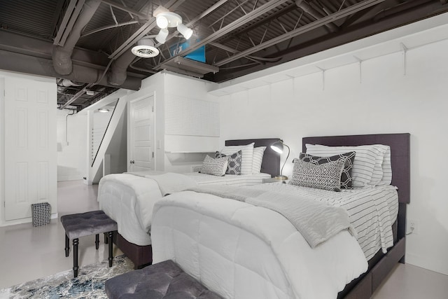 bedroom featuring concrete flooring