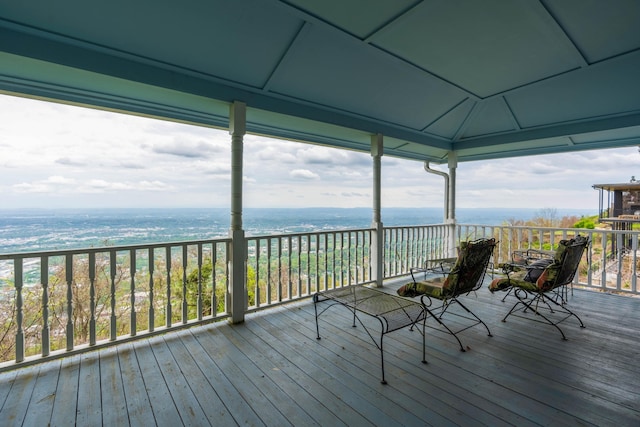 wooden deck featuring a water view