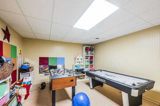 game room featuring light colored carpet and a drop ceiling