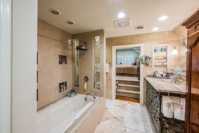 bathroom featuring tile floors, vanity, and independent shower and bath