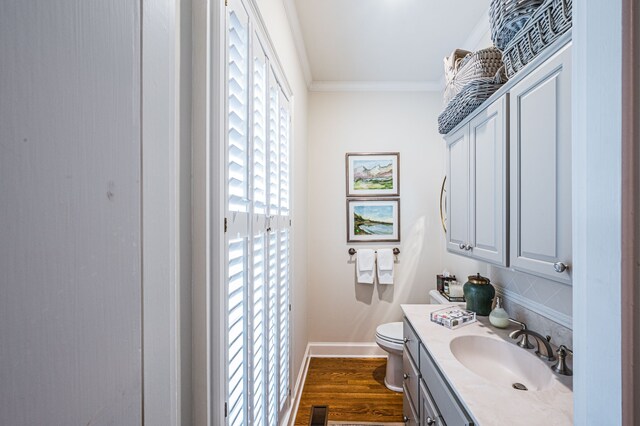 bathroom featuring crown molding, toilet, large vanity, and wood-type flooring