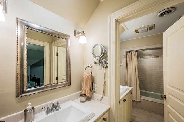 bathroom with vanity and lofted ceiling