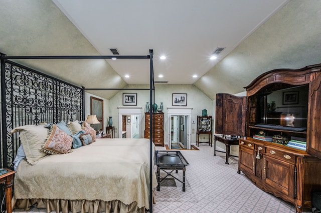 bedroom with lofted ceiling and light colored carpet