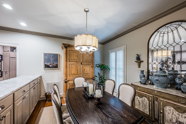 dining area featuring crown molding and dark wood-type flooring