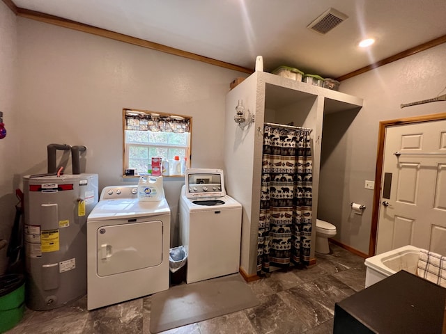 washroom featuring separate washer and dryer, water heater, and crown molding