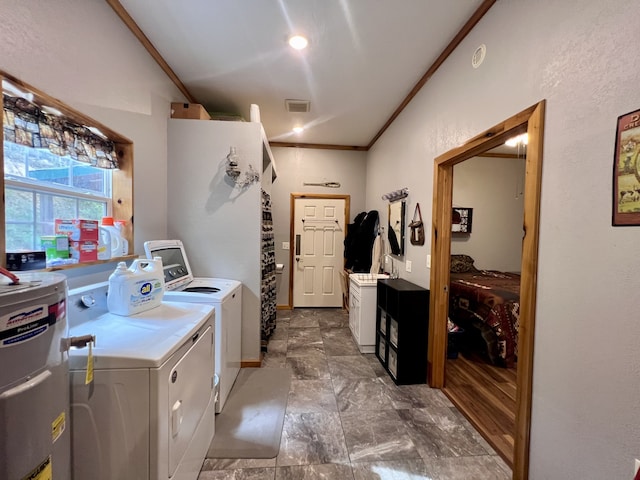 laundry room featuring water heater, washer and clothes dryer, and crown molding