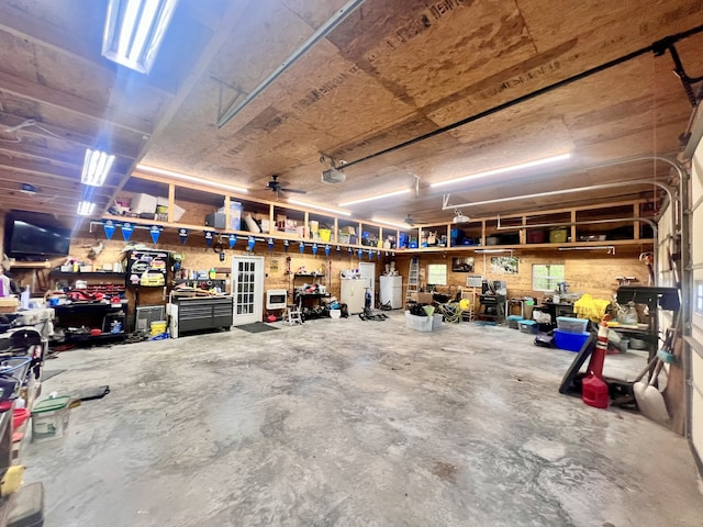 garage featuring a workshop area and ceiling fan