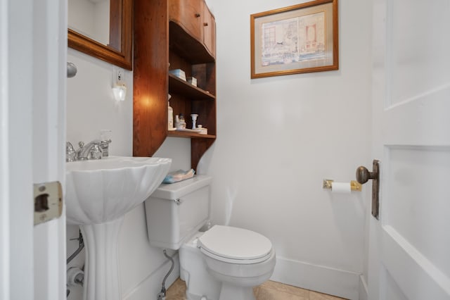 bathroom with toilet and tile flooring