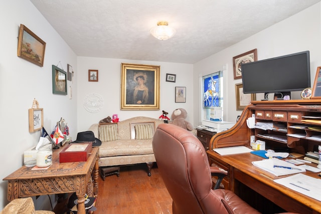 office area with a textured ceiling and hardwood / wood-style flooring
