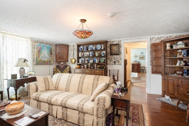 living room featuring a textured ceiling and dark hardwood / wood-style flooring
