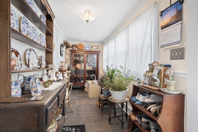 interior space featuring dark tile floors and ornamental molding