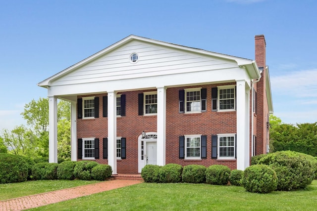 greek revival inspired property featuring a front yard