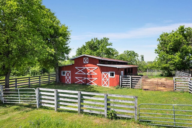 view of horse barn with a rural view