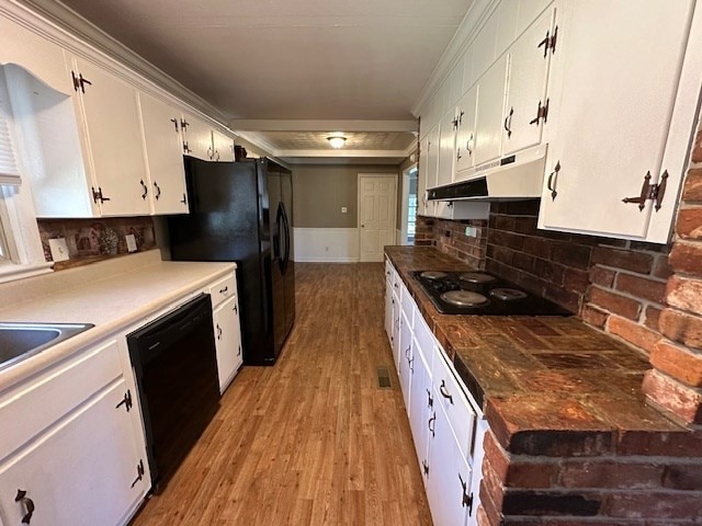 kitchen featuring black appliances, backsplash, light hardwood / wood-style floors, and white cabinets