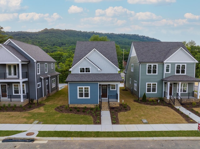 view of front of house with a porch and a front lawn