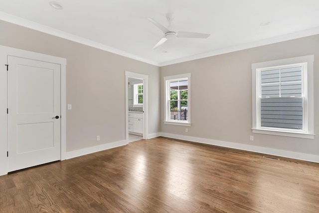 spare room featuring ornamental molding, ceiling fan, and wood-type flooring