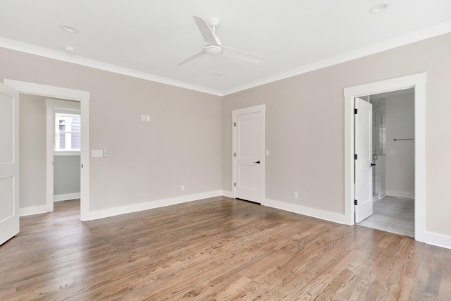 unfurnished bedroom with ensuite bathroom, ceiling fan, wood-type flooring, and ornamental molding