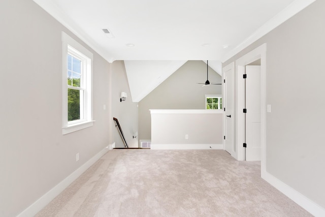 additional living space featuring ceiling fan, vaulted ceiling, and light carpet