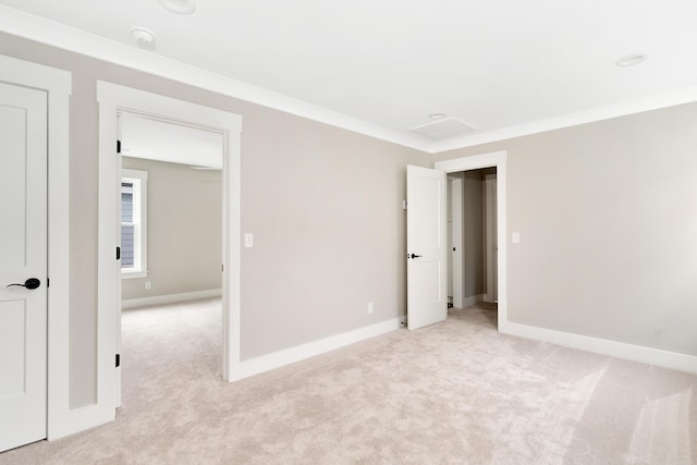 unfurnished bedroom featuring crown molding and light carpet