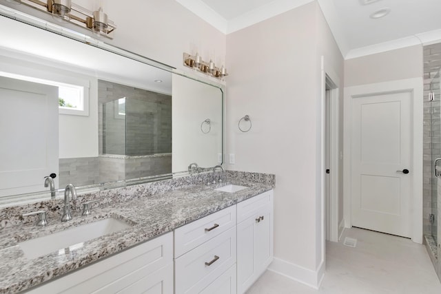 bathroom featuring a stall shower, crown molding, and a sink